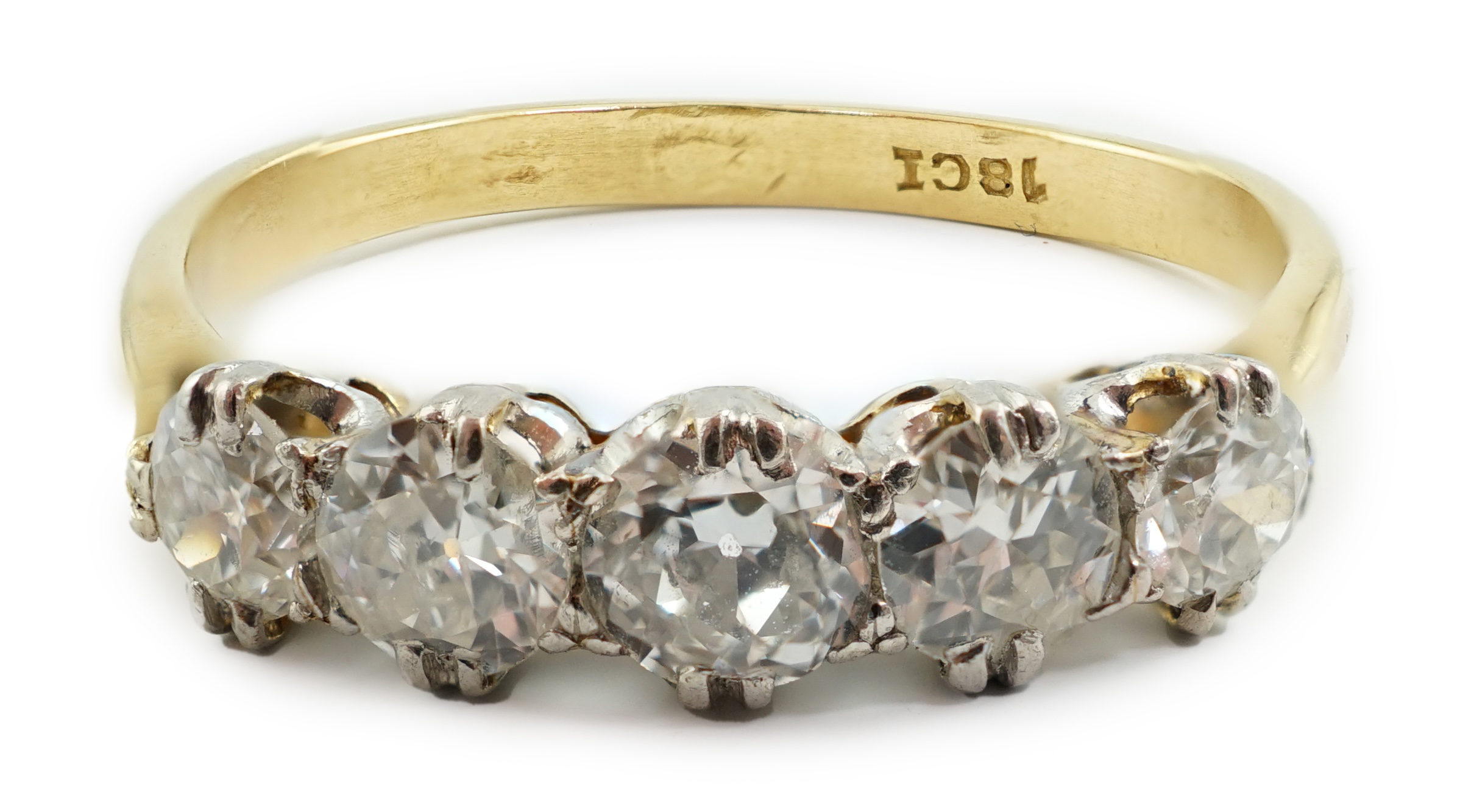 An 18ct gold and graduated five stone diamond set half hoop ring